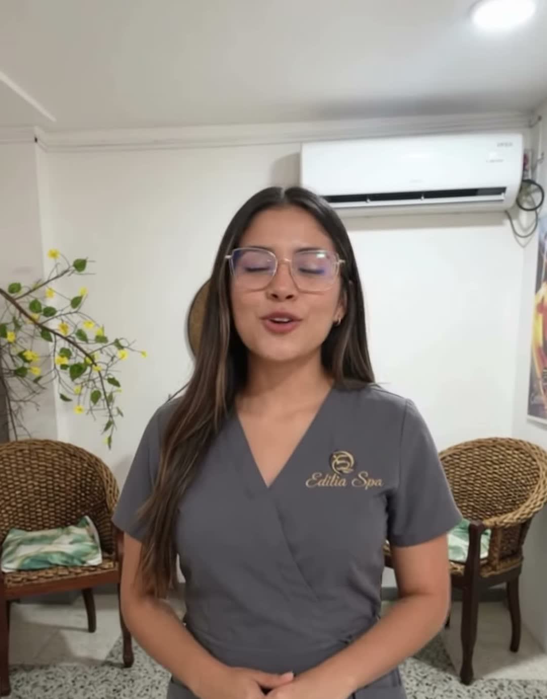 Integrante del equipo de Edilia Spa con uniforme gris y el logo bordado, en la sala de espera